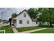 Side view of a charming house featuring white siding, brown trim, and well-maintained landscaping at 35 Meadow Dr, New Palestine, IN 46163