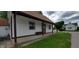 Charming single-story home with a brown roof, white siding, and a cozy front porch at 35 Meadow Dr, New Palestine, IN 46163