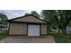 Detached garage with a clean white door at 35 Meadow Dr, New Palestine, IN 46163