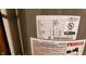 Close-up of water heater displaying model and serial number information at 35 Meadow Dr, New Palestine, IN 46163