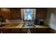 Kitchen features a stainless sink, window, and wood cabinets at 35 Meadow Dr, New Palestine, IN 46163