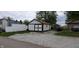 Detached outbuilding with white siding and brown trim, offering extra storage or workspace at 35 Meadow Dr, New Palestine, IN 46163