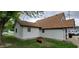 Rear view of a house with white siding, brown trim, and a well-maintained yard at 35 Meadow Dr, New Palestine, IN 46163