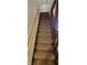Carpeted staircase with wooden handrail at 35 Meadow Dr, New Palestine, IN 46163