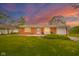 Charming red brick home featuring a well-manicured lawn and inviting front porch with seating at 3846 Alsace Pl, Indianapolis, IN 46226