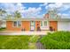 Inviting red brick home with a tidy front yard, seating on the front porch, and a well-maintained exterior at 3846 Alsace Pl, Indianapolis, IN 46226