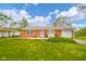 Charming red brick home featuring a well-manicured lawn and inviting front porch with seating at 3846 Alsace Pl, Indianapolis, IN 46226