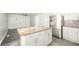 Kitchen island with granite counter top, stainless steel appliances and white cabinets at 3846 Alsace Pl, Indianapolis, IN 46226