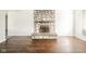 Cozy living room featuring a stone fireplace and sleek, wood floors at 3846 Alsace Pl, Indianapolis, IN 46226