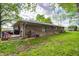 Brick home's backyard featuring an attached deck, greenery, and a lawn at 4080 S London Dr, Martinsville, IN 46151