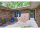 Exterior entrance boasts brick facade, blue chair and decorative window at 4080 S London Dr, Martinsville, IN 46151