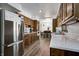 Galley kitchen with stainless steel appliances and view into dining area at 4080 S London Dr, Martinsville, IN 46151