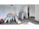 Neutral playroom features wood floor with play tent and toys galore at 4080 S London Dr, Martinsville, IN 46151