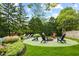 Backyard features a fire pit and comfortable seating with lush landscaping at 4619 Allen Dr, Carmel, IN 46033