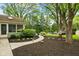 Lush backyard with a serene garden path, leading to the pool and fire pit at 4619 Allen Dr, Carmel, IN 46033