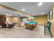 Finished basement with a cozy seating area, a pool table, and a projector screen for entertainment at 4619 Allen Dr, Carmel, IN 46033