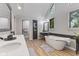 Bright bathroom with double sinks, white countertops, and a standalone tub, ideal for relaxation and luxury at 4619 Allen Dr, Carmel, IN 46033