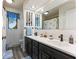 Well-lit bathroom featuring double sinks and blue accents at 4619 Allen Dr, Carmel, IN 46033
