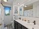 Bright bathroom with double vanity, blue accents, and wood-look flooring at 4619 Allen Dr, Carmel, IN 46033