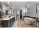 Spacious bathroom with double vanity, soaking tub, and a bright design at 4619 Allen Dr, Carmel, IN 46033