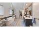 Bright bathroom featuring a soaking tub, double vanity, and walk-in closet at 4619 Allen Dr, Carmel, IN 46033