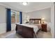 Cozy bedroom with a wooden bed frame, complemented by soft lighting and a warm atmosphere at 4619 Allen Dr, Carmel, IN 46033