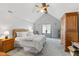 Bright bedroom with vaulted ceilings, ceiling fan, a large window, and warm wood furniture offering a comfortable ambiance at 4619 Allen Dr, Carmel, IN 46033