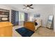 Comfortable bedroom with bay window, ceiling fan, and a full-length mirror at 4619 Allen Dr, Carmel, IN 46033