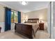 Comfortable bedroom with a large window, dark wood furniture, and neutral-toned walls, creating a relaxing atmosphere at 4619 Allen Dr, Carmel, IN 46033