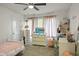Cozy bedroom featuring a ceiling fan, white walls and furniture, and a window with lots of natural light at 4619 Allen Dr, Carmel, IN 46033