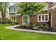 Inviting front entrance with a curved walkway, decorative landscaping, and a well-maintained brick facade at 4619 Allen Dr, Carmel, IN 46033
