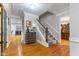 Hallway with hardwood floors, staircase, gray walls, and white trim at 4619 Allen Dr, Carmel, IN 46033
