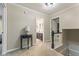 Bright hallway leading to a bathroom and bedroom, featuring neutral walls and a staircase, offering a warm welcome at 4619 Allen Dr, Carmel, IN 46033