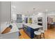 Stylish kitchen with white cabinets, a blue island, stainless steel appliances, and hardwood floors at 4619 Allen Dr, Carmel, IN 46033