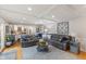 Spacious living room with coffered ceilings, hardwood floors, and a comfortable seating area with gray leather furniture at 4619 Allen Dr, Carmel, IN 46033