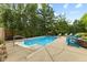 Backyard swimming pool with surrounding deck, landscaping, lounge chairs, and privacy fence at 4619 Allen Dr, Carmel, IN 46033