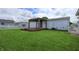 Lush backyard features a gazebo with wooden deck, fire pit, and expansive lawn for outdoor enjoyment at 4632 Willowbrook Dr, Columbus, IN 47203