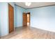 Bedroom featuring two wooden doors and wood-look flooring at 4632 Willowbrook Dr, Columbus, IN 47203