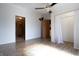 Bedroom with wood-look floors, walk-in closet, and ceiling fan at 4632 Willowbrook Dr, Columbus, IN 47203