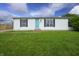 Cozy single-story home with a green lawn, quaint shutters, and a bright, inviting front door at 4632 Willowbrook Dr, Columbus, IN 47203