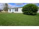 Classic single-story home with a well-manicured lawn and a lovely green shrub in the front yard at 4632 Willowbrook Dr, Columbus, IN 47203