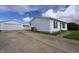 Property featuring a long driveway, detached garage, and a well-maintained one-story home at 4632 Willowbrook Dr, Columbus, IN 47203