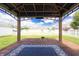 Relaxing gazebo with a cozy outdoor rug, perfect for enjoying serene backyard views on a wooden deck at 4632 Willowbrook Dr, Columbus, IN 47203