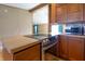 Charming kitchen features stainless steel appliances, wood cabinets, and a smooth cooktop for modern cooking at 4632 Willowbrook Dr, Columbus, IN 47203