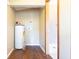Laundry room with wood-look floors and adjacent access to the updated bathroom at 4632 Willowbrook Dr, Columbus, IN 47203