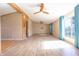 Sun-drenched living area featuring sleek wood-look floors, open floor plan, and modern ceiling fan at 4632 Willowbrook Dr, Columbus, IN 47203