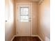 Mud room with wood-look floors, utility door with glass, and access to outdoors at 4632 Willowbrook Dr, Columbus, IN 47203