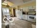 Bright eat-in kitchen features white appliances, wood floors, and ample counter space at 4655 Framington Ct, Indianapolis, IN 46254