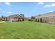 Large backyard with green grass and a wooden fence for privacy in a suburban setting at 4711 Bentley Dr, Carmel, IN 46033