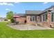 Brick home's backyard featuring a patio, table, chairs, umbrella and green grass perfect for relaxing at 4711 Bentley Dr, Carmel, IN 46033